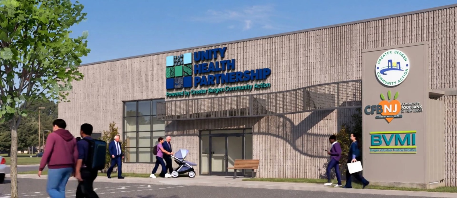 Familias llegan a la entrada principal del edificio de Unity Health Partnership en 529 Midland Ave, donde el evento se realiza en el estacionamiento